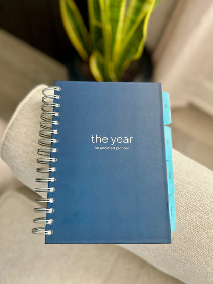 the year - a navy, spiral Orthodox undated life planner with four tabs of resources for organizing your days, keeping your faith close, maintaining your home and knowing where your finances stand - all at your fingertips.